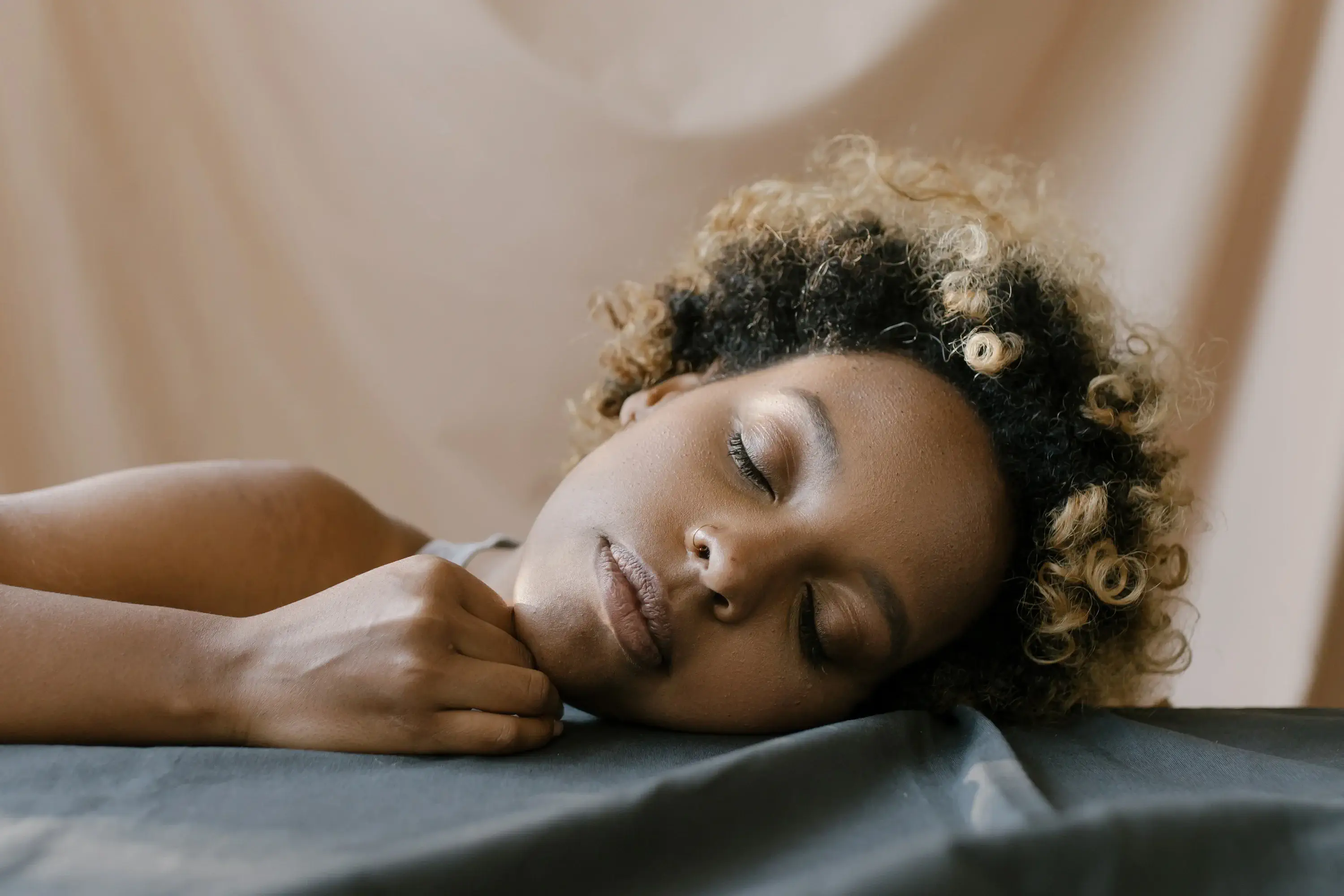 a woman tilting her head to the side with her eyes closed